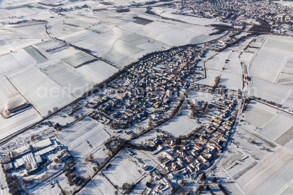 Niederhorbach from the bird's eye view: Wintry snowy village - view on the edge of agricultural fields and farmland in Niederhorbach in the state Rhineland-Palatinate, Germany