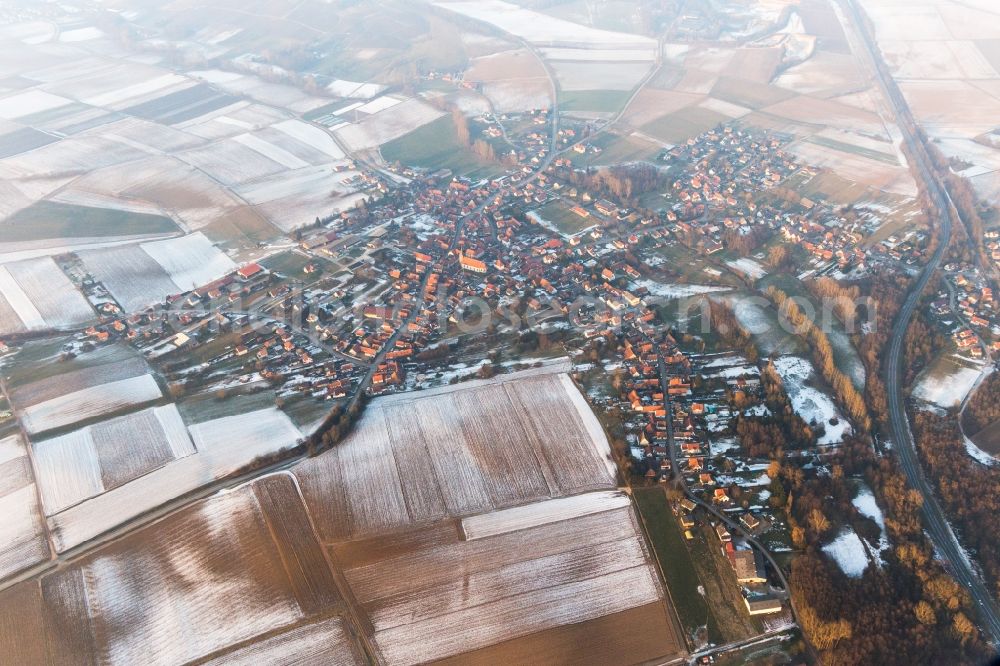 Riedseltz from above - Wintry snowy Village - view on the edge of agricultural fields and farmland in Riedseltz in Grand Est, France