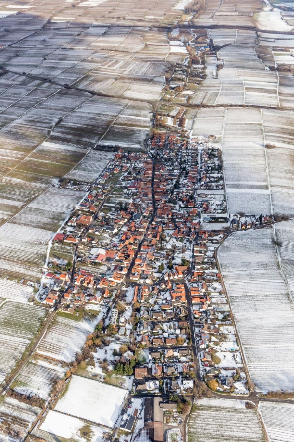 Aerial image Roschbach - Wintry snowy Village - view on the edge of agricultural fields and farmland in Roschbach in the state Rhineland-Palatinate, Germany