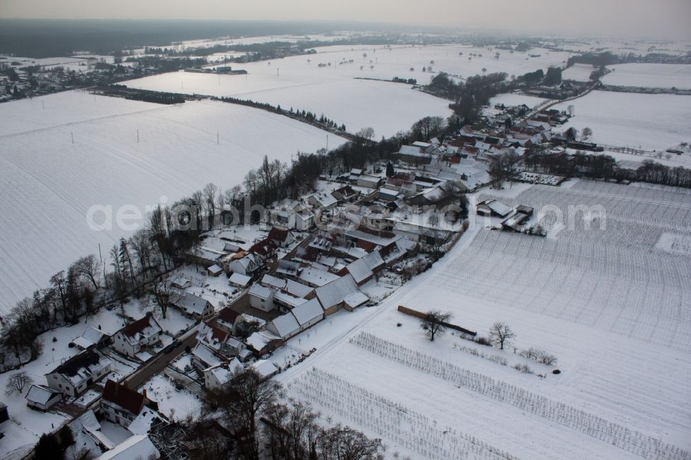 Aerial photograph Vollmersweiler - Wintry snowy Village - view on the edge of agricultural fields and farmland in Vollmersweiler in the state Rhineland-Palatinate, Germany