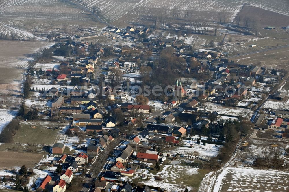 Willmersdorf from the bird's eye view: Wintry snowy Village view in Willmersdorf in the state Brandenburg