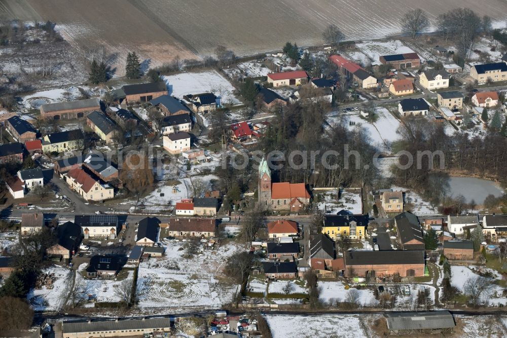 Willmersdorf from the bird's eye view: Wintry snowy Village view in Willmersdorf in the state Brandenburg