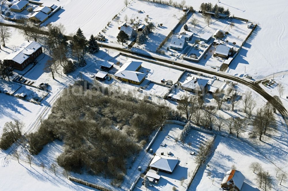 Wüsteney from the bird's eye view: Wintry snowy village view in Wuesteney in the state Mecklenburg - Western Pomerania, Germany