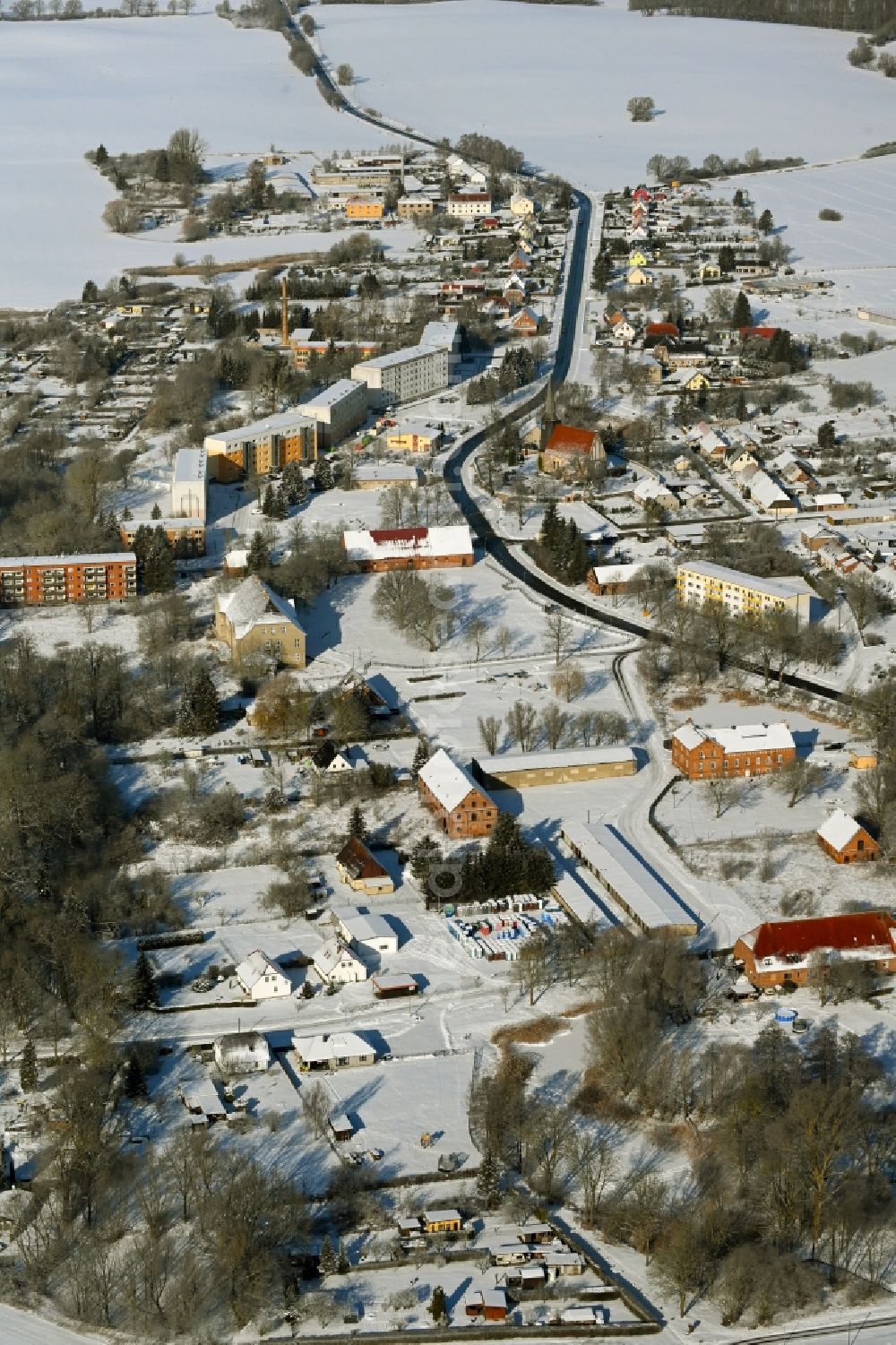 Cölpin from above - Wintry snowy agricultural land and field boundaries surround the settlement area of the village in Coelpin in the state Mecklenburg - Western Pomerania, Germany