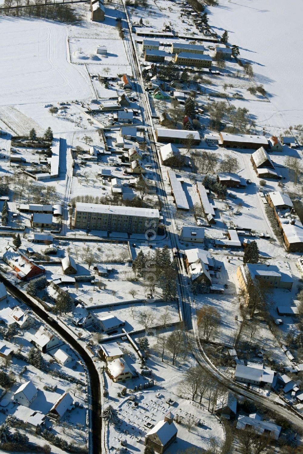 Aerial image Kletzin - Wintry snowy agricultural land and field boundaries surround the settlement area of the village in Kletzin in the state Mecklenburg - Western Pomerania, Germany