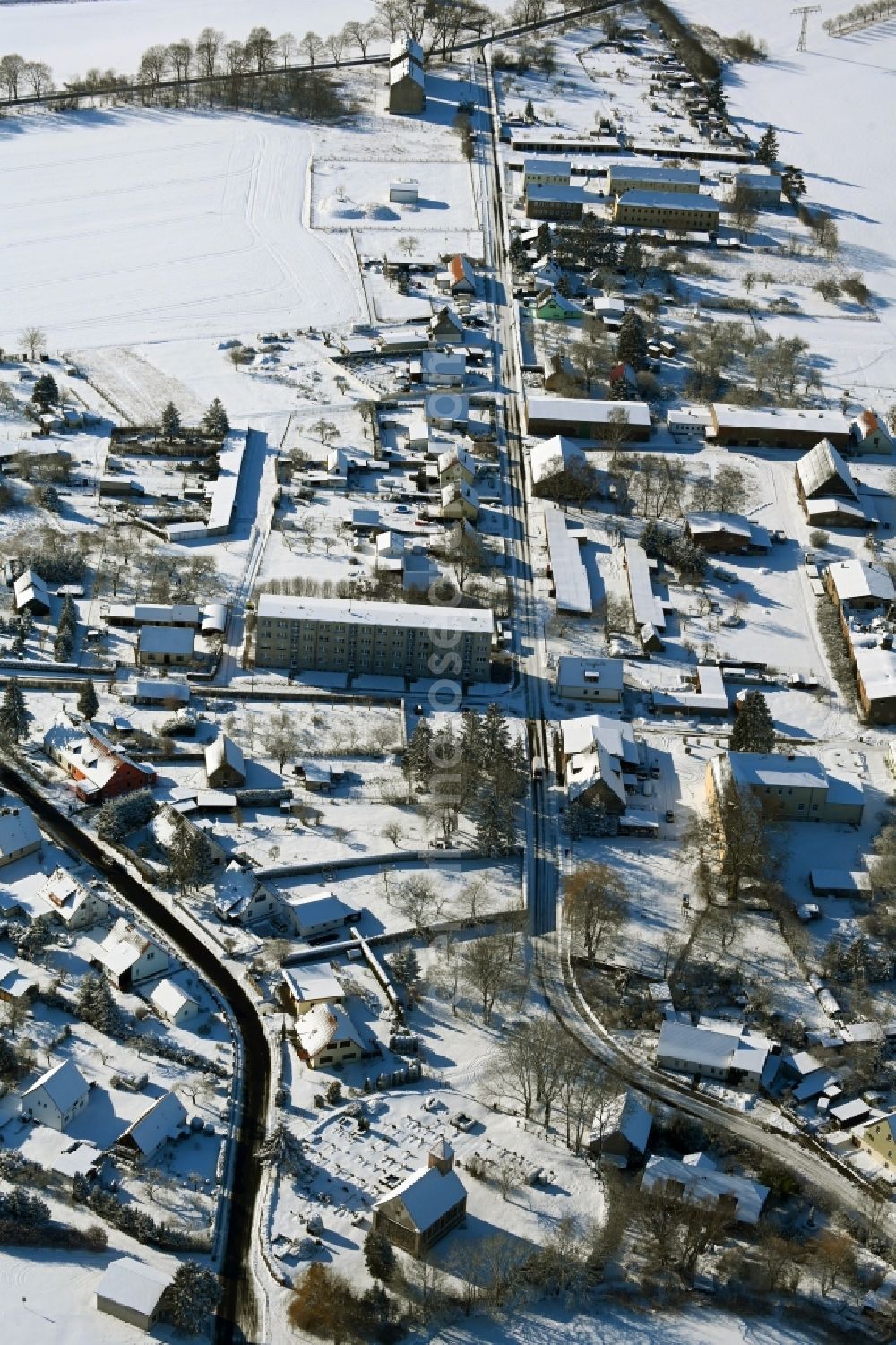 Aerial photograph Kletzin - Wintry snowy agricultural land and field boundaries surround the settlement area of the village in Kletzin in the state Mecklenburg - Western Pomerania, Germany