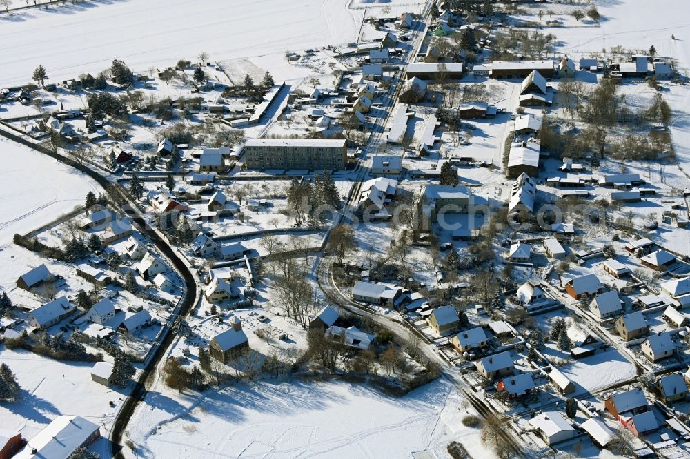 Kletzin from above - Wintry snowy agricultural land and field boundaries surround the settlement area of the village in Kletzin in the state Mecklenburg - Western Pomerania, Germany