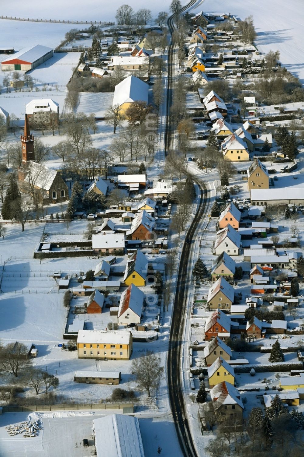 Leppin from the bird's eye view: Wintry snowy agricultural land and field boundaries surround the settlement area of the village in Leppin in the state Mecklenburg - Western Pomerania, Germany