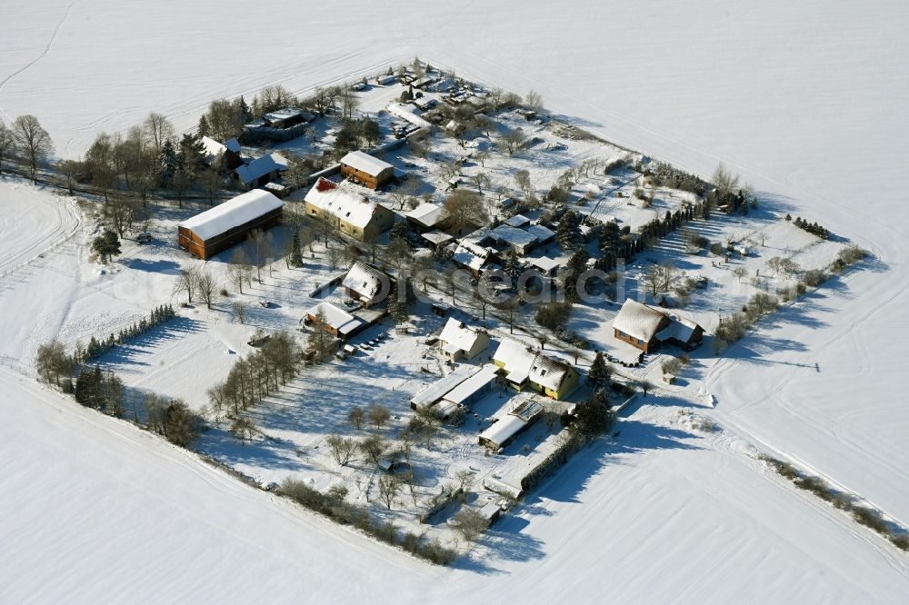 Rosemarsow from the bird's eye view: Wintry snowy agricultural land and field boundaries surround the settlement area of the village in Rosemarsow in the state Mecklenburg - Western Pomerania, Germany