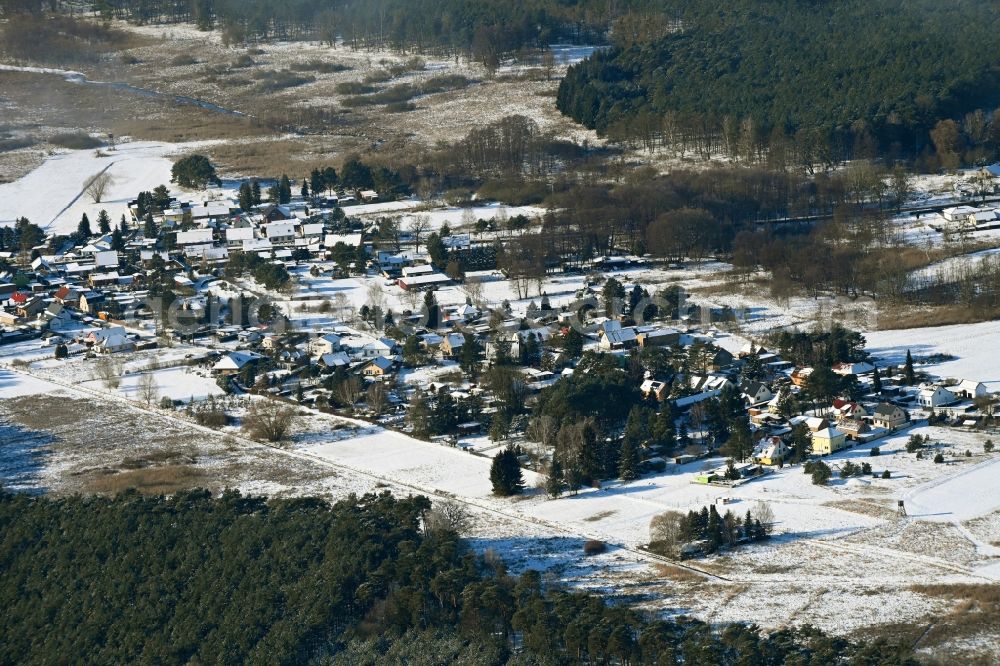 Sophienstädt from the bird's eye view: Wintry snowy agricultural land and field boundaries surround the settlement area of the village in Sophienstaedt in the state Brandenburg, Germany