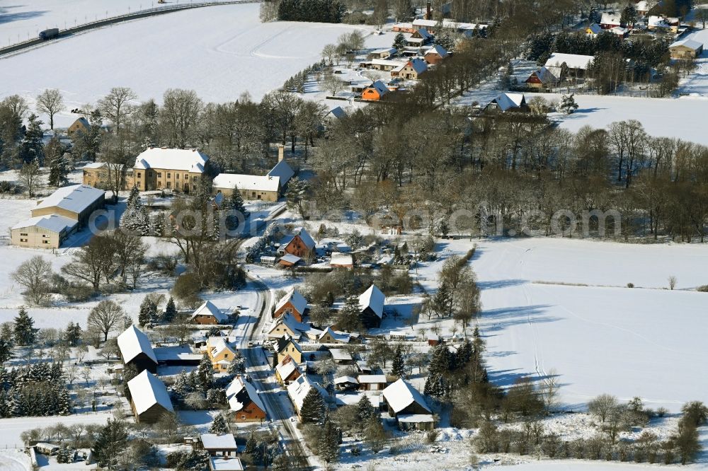 Tentzerow from above - Wintry snowy agricultural land and field boundaries surround the settlement area of the village in Tentzerow in the state Mecklenburg - Western Pomerania, Germany