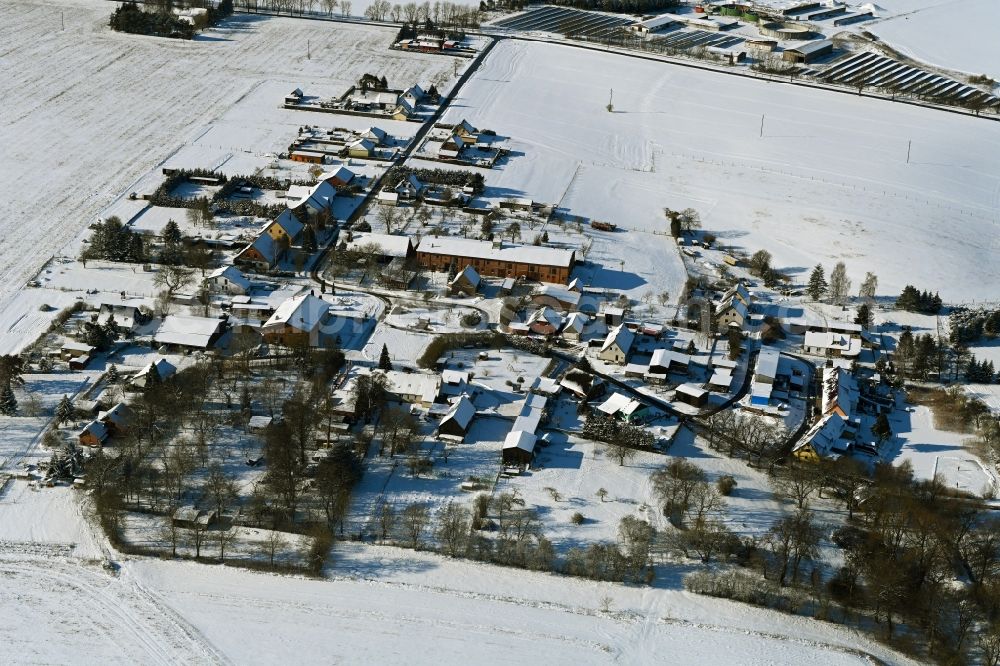 Aerial photograph Thalberg - Wintry snowy agricultural land and field boundaries surround the settlement area of the village in Thalberg in the state Mecklenburg - Western Pomerania, Germany