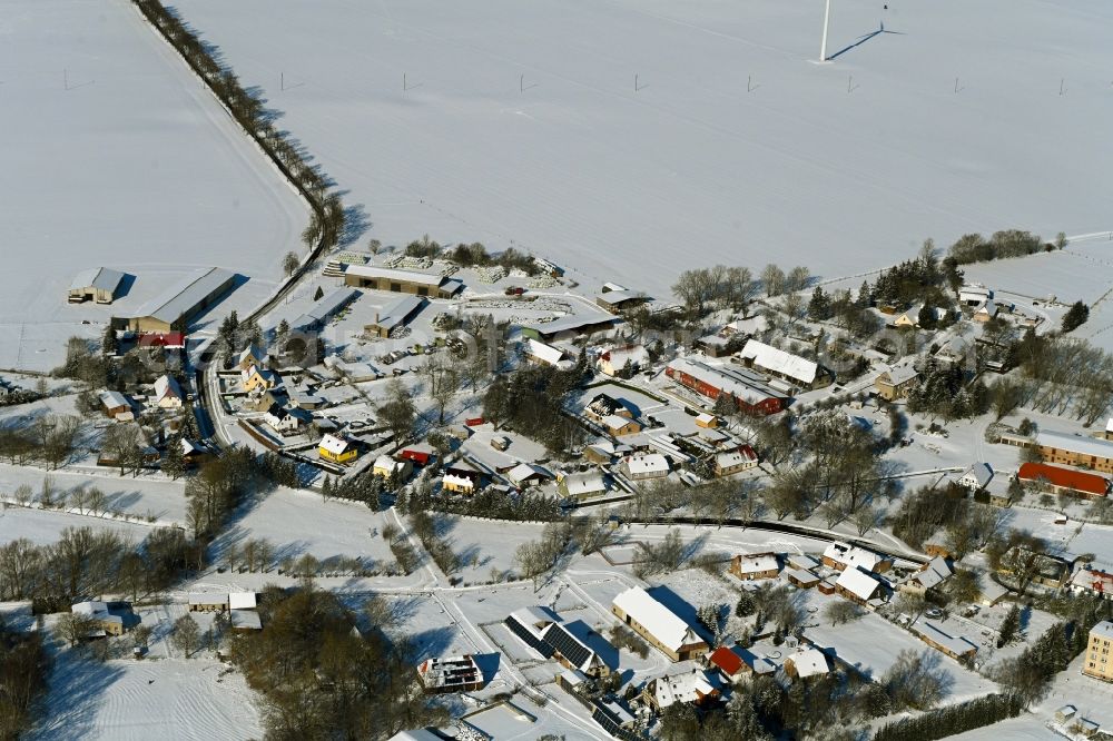 Vorbein from above - Wintry snowy agricultural land and field boundaries surround the settlement area of the village in Vorbein in the state Mecklenburg - Western Pomerania, Germany