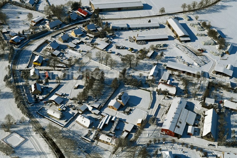 Aerial image Vorbein - Wintry snowy agricultural land and field boundaries surround the settlement area of the village in Vorbein in the state Mecklenburg - Western Pomerania, Germany