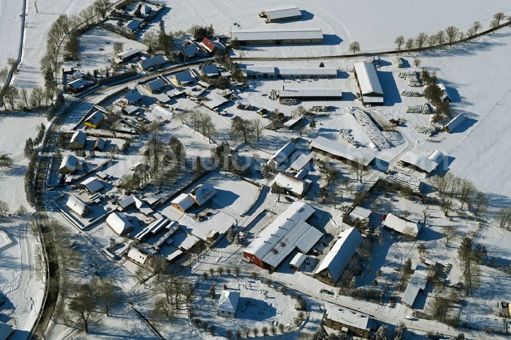 Vorbein from above - Wintry snowy agricultural land and field boundaries surround the settlement area of the village in Vorbein in the state Mecklenburg - Western Pomerania, Germany