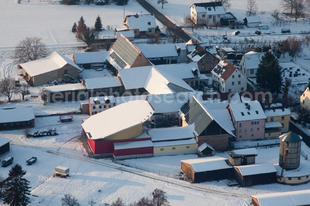 Aerial photograph Kapellen-Drusweiler - Wintry snowy Panel rows of photovoltaic turnable roof of a stable in the district Deutschhof in Kapellen-Drusweiler in the state Rhineland-Palatinate