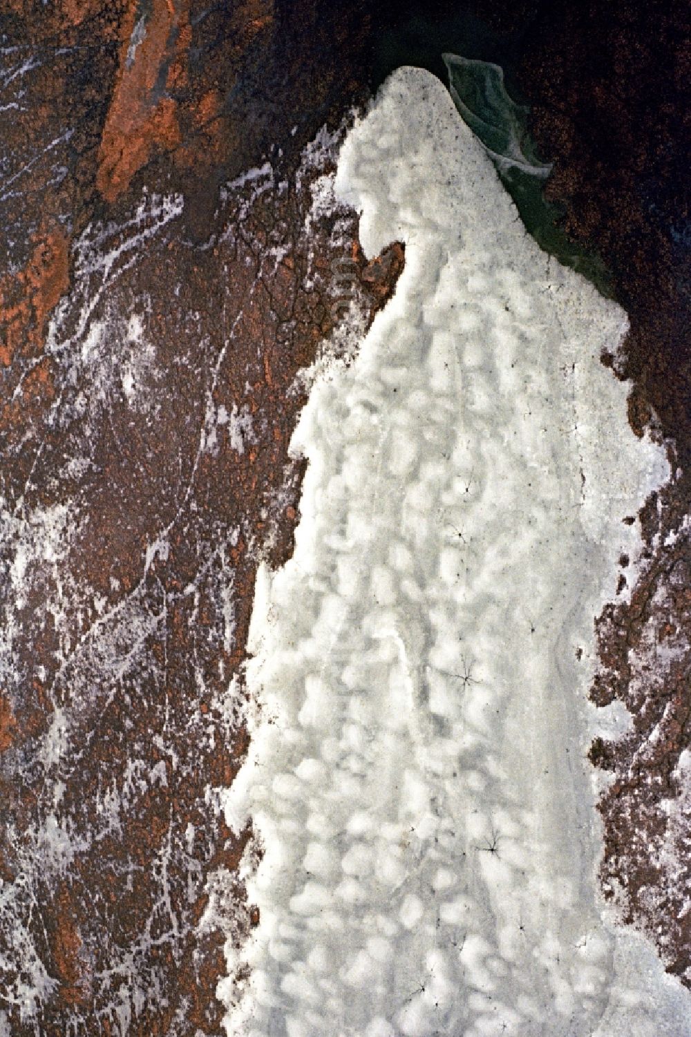 Neutrebbin from the bird's eye view: Wintry snowy Agricultural fields embossed of soil erosion and ice and snow structures in Neutrebbin in the state Brandenburg, Germany