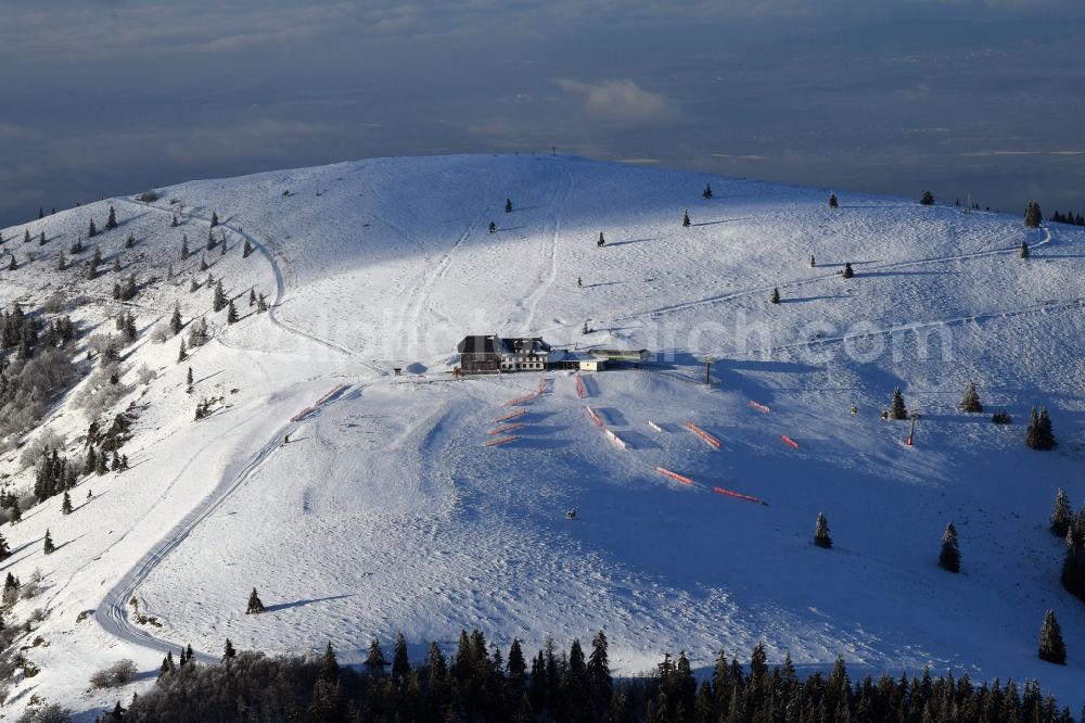 Kleines Wiesental from above - Wintry snowy forest and mountain scenery in the Black Forest with the snow covered summit of Belchen in Kleines Wiesental in the state Baden-Wurttemberg, Germany