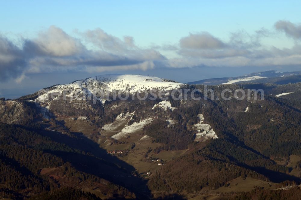 Aerial image Kleines Wiesental - Wintry snowy forest and mountain scenery in the Black Forest with the snow covered summit of Belchen in Kleines Wiesental in the state Baden-Wuerttemberg, Germany