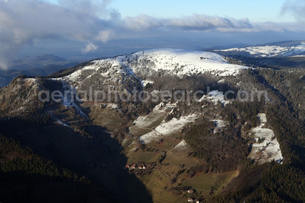 Aerial photograph Kleines Wiesental - Wintry snowy forest and mountain scenery in the Black Forest with the snow covered summit of Belchen in Kleines Wiesental in the state Baden-Wuerttemberg, Germany