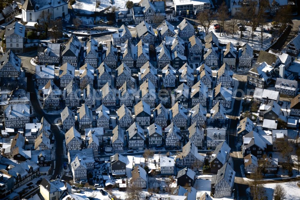 Freudenberg from above - Wintry snowy half-timbered house and multi-family house- residential area in the old town area and inner city center Marktstrasse - Unterstrasse - Poststrasse in Freudenberg in the state North Rhine-Westphalia