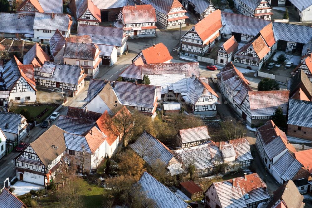 Eschbach from above - Wintry snowy Half-timbered house residential area in the old village area in Eschbach in Grand Est, France