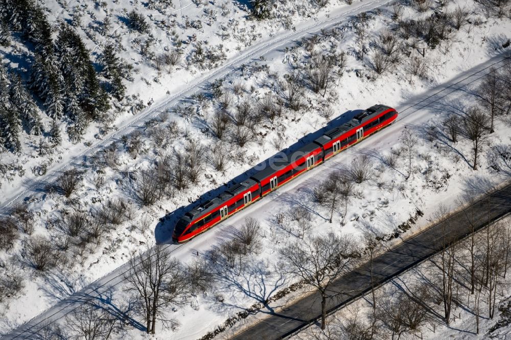 Silbach from above - Wintry snowy driving a Regional Express - train on the track route in Silbach in the state North Rhine-Westphalia, Germany