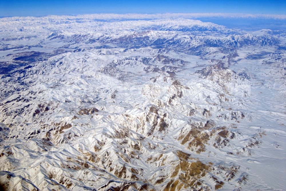 Aerial image Kandahar - Wintry snowy rock and mountain landscape Hindu Kush in Kandahar in Afghanistan