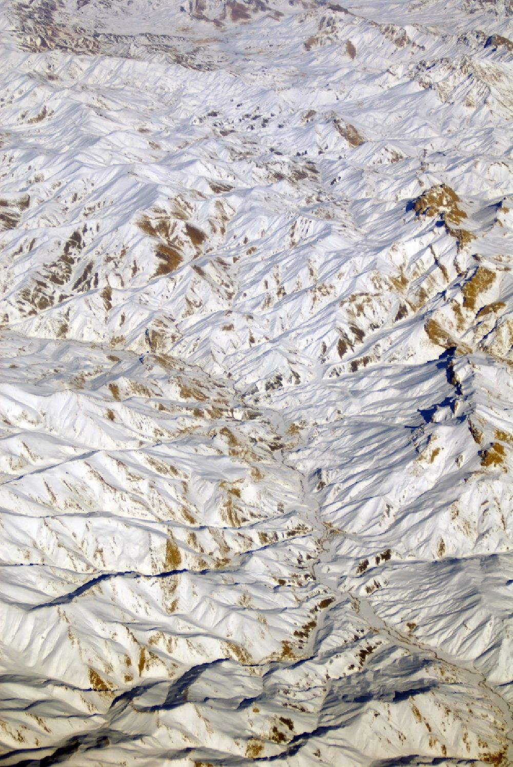 Kandahar from the bird's eye view: Wintry snowy rock and mountain landscape Hindu Kush in Kandahar in Afghanistan