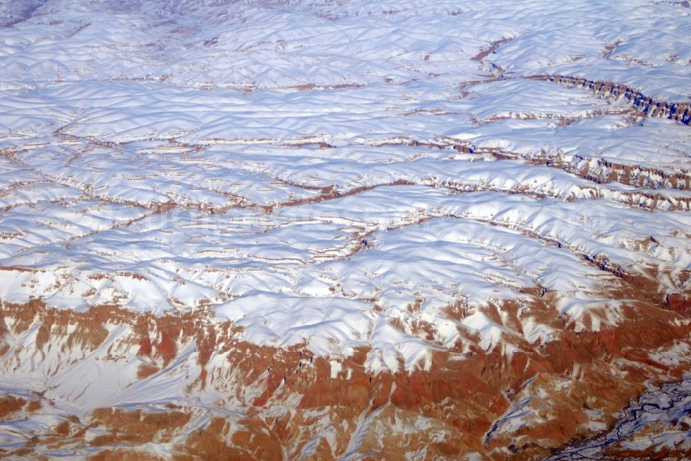 Aerial image Kandahar - Wintry snowy rock and mountain landscape Hindu Kush in Kandahar in Afghanistan