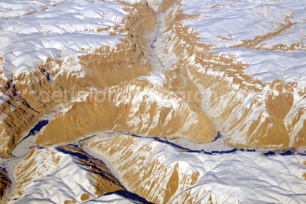 Kandahar from above - Wintry snowy rock and mountain landscape Hindu Kush in Kandahar in Afghanistan