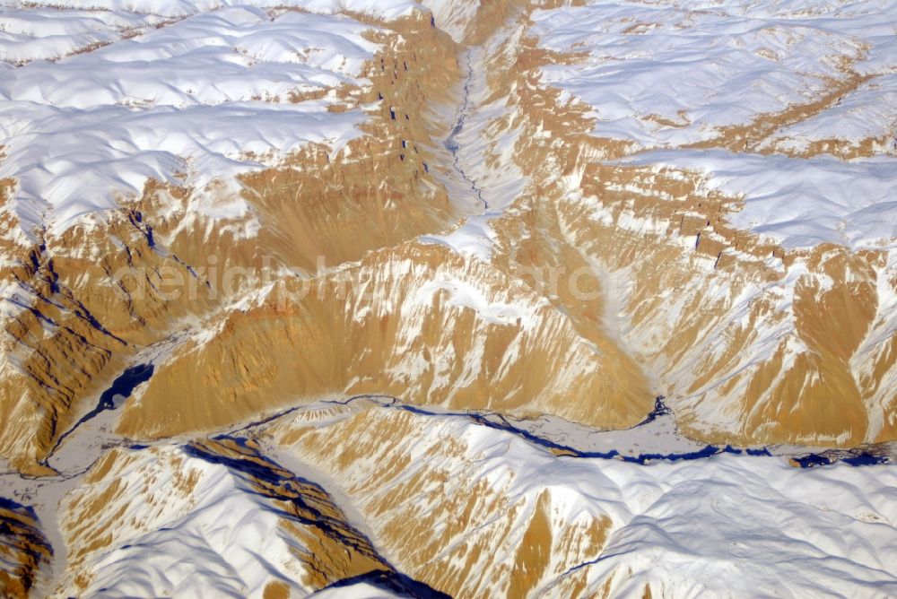 Kandahar from the bird's eye view: Wintry snowy rock and mountain landscape Hindu Kush in Kandahar in Afghanistan