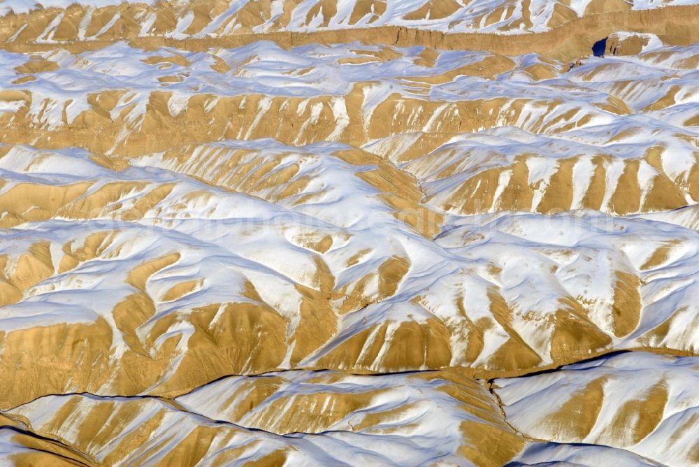 Aerial image Kandahar - Wintry snowy rock and mountain landscape Hindu Kush in Kandahar in Afghanistan