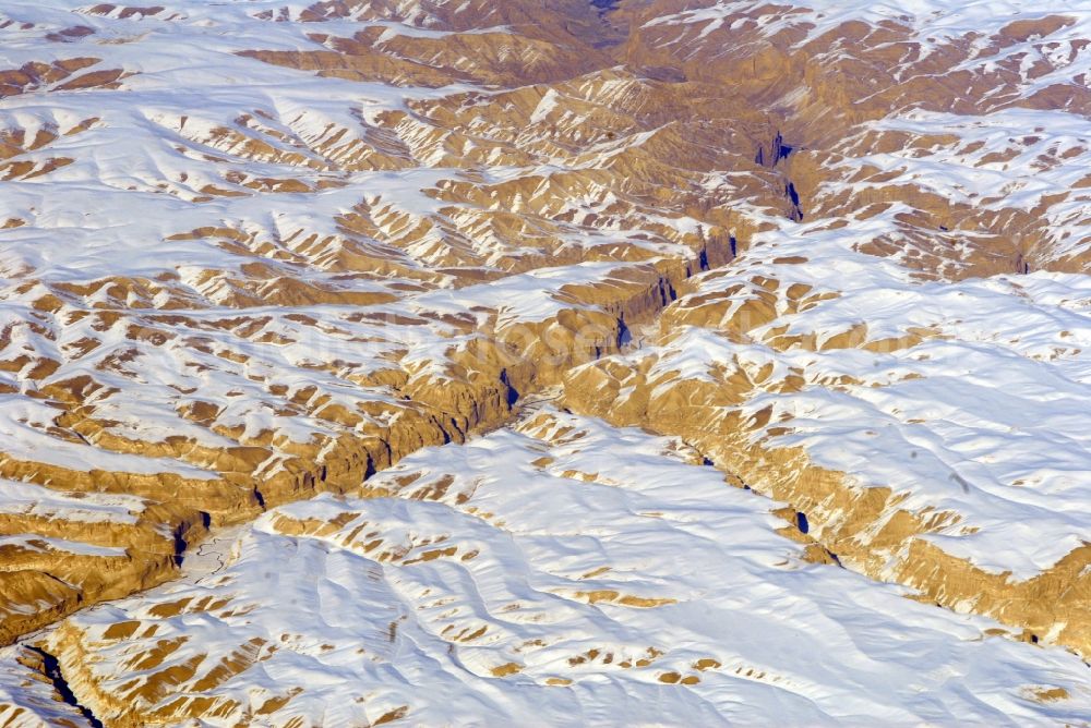 Kandahar from above - Wintry snowy rock and mountain landscape Hindu Kush in Kandahar in Afghanistan