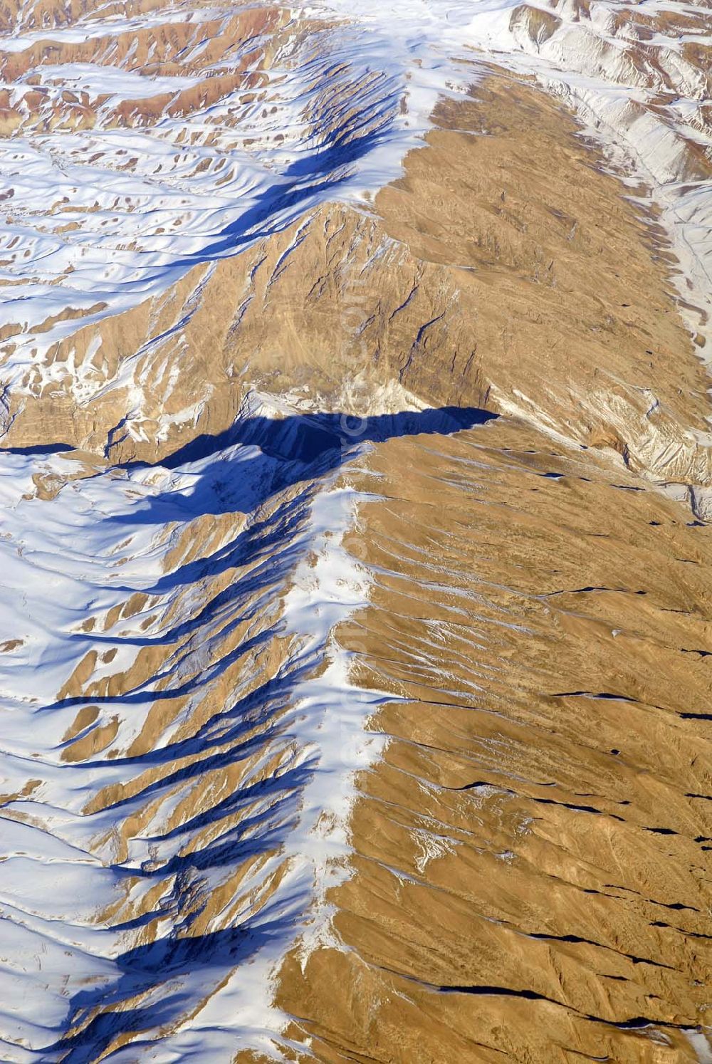 Aerial image Kandahar - Wintry snowy rock and mountain landscape Hindu Kush in Kandahar in Afghanistan