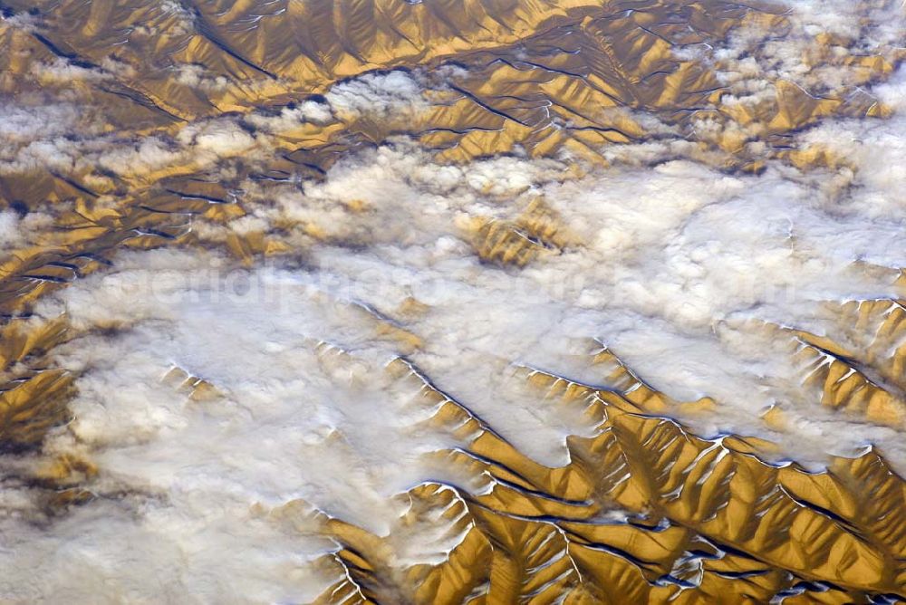 Aerial image Kandahar - Wintry snowy rock and mountain landscape Hindu Kush in Kandahar in Afghanistan