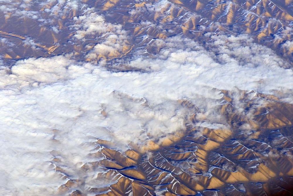 Aerial image Kandahar - Wintry snowy rock and mountain landscape Hindu Kush in Kandahar in Afghanistan