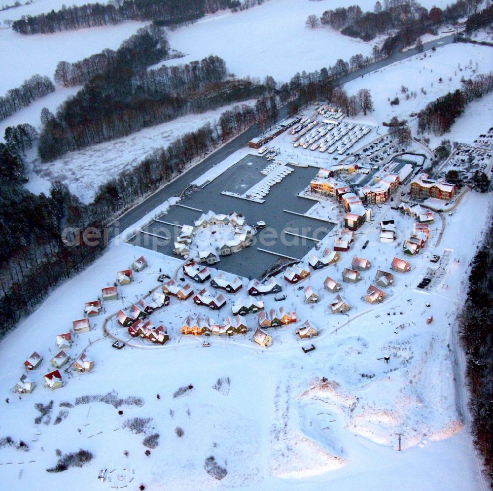 Kleinzerlang from the bird's eye view: Wintry snowy holiday house plant of the park Marina Wolfsbruch in Kleinzerlang in the state Brandenburg, Germany