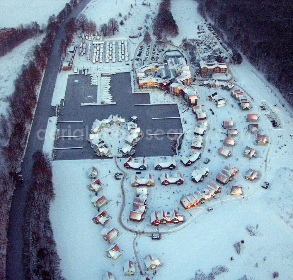 Kleinzerlang from the bird's eye view: Wintry snowy holiday house plant of the park Marina Wolfsbruch in Kleinzerlang in the state Brandenburg, Germany