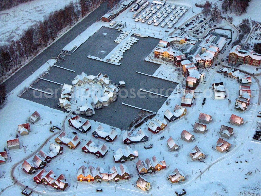 Aerial image Kleinzerlang - Wintry snowy holiday house plant of the park Marina Wolfsbruch in Kleinzerlang in the state Brandenburg, Germany