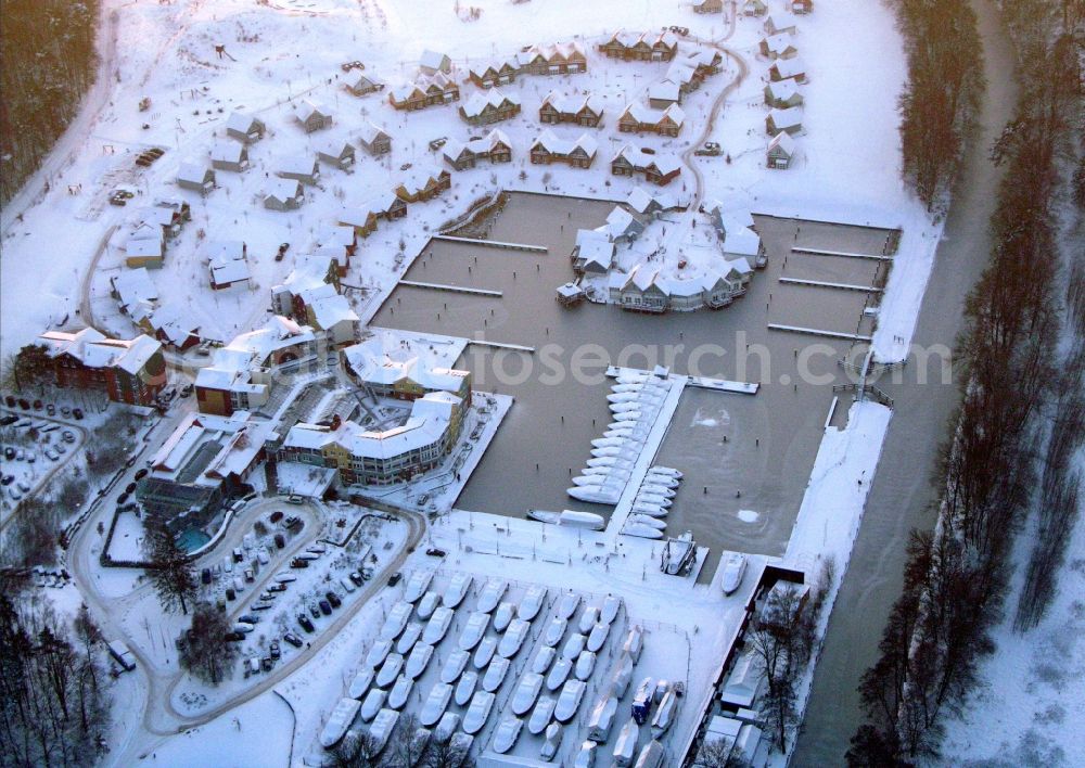 Aerial image Kleinzerlang - Wintry snowy holiday house plant of the park Marina Wolfsbruch in Kleinzerlang in the state Brandenburg, Germany