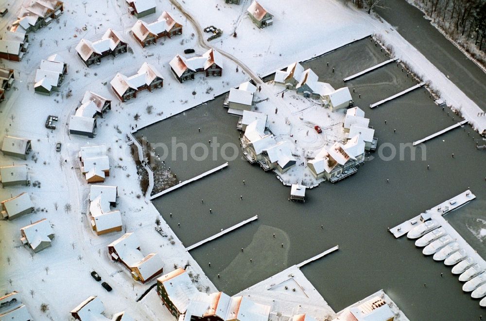 Aerial image Kleinzerlang - Wintry snowy holiday house plant of the park Marina Wolfsbruch in Kleinzerlang in the state Brandenburg, Germany