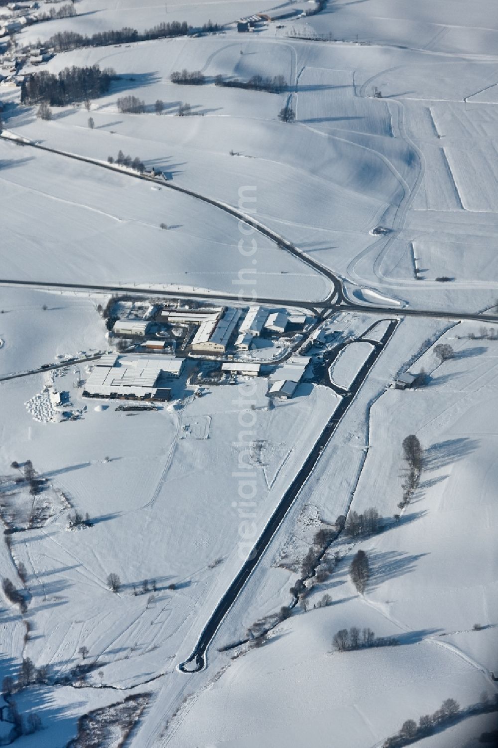 Arnbruck from the bird's eye view: Wintery snow-covered airfield Arnbruck in the state of Bavaria, Germany. The airfield with the identifier EDNB is a special landing site in the Bavarian Forest. Here is a base of Luftrettungsstaffel Bayern e. V