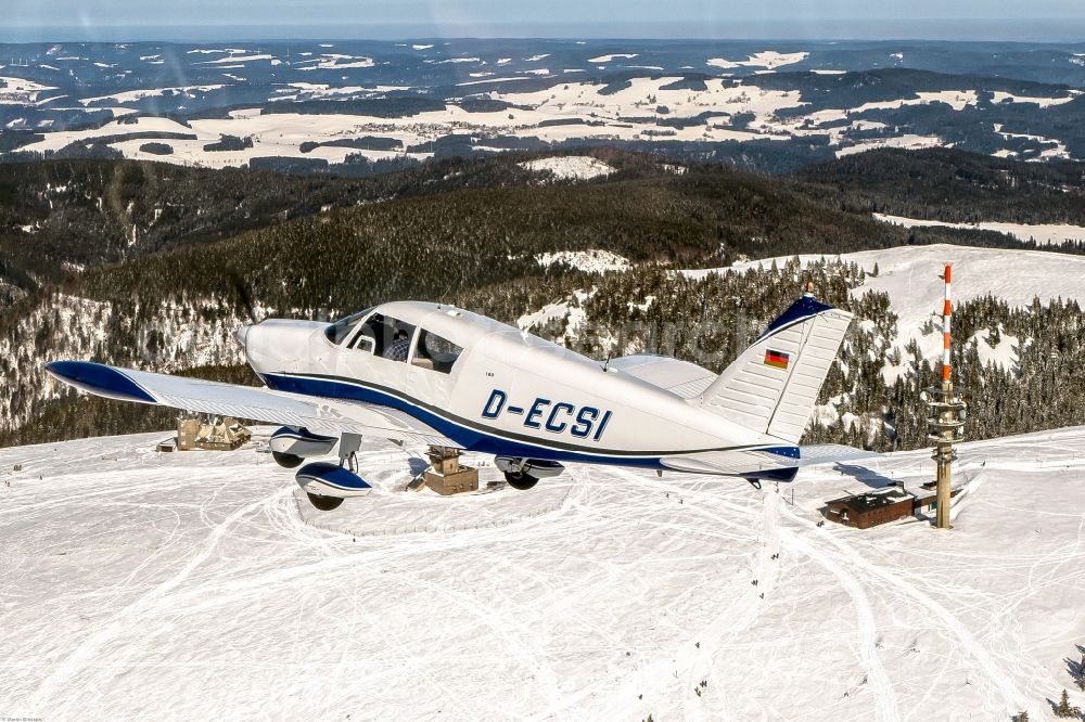 Aerial photograph Feldberg (Schwarzwald) - Wintry snowy piper Pa28 Aircraft in flight over the airspace in Feldberg (Schwarzwald) in the state Baden-Wurttemberg, Germany