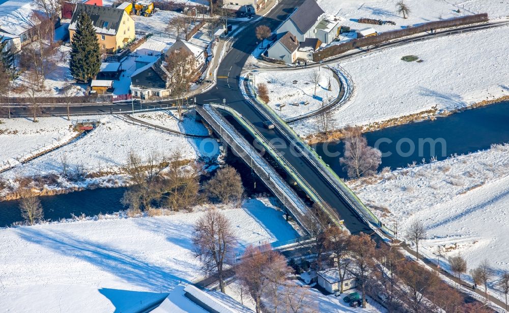 Aerial image Arnsberg - Wintry snowy Scenery, building and the river - bridge building work over the Ruhr in the district of Oeventrop in Arnsberg in the federal state North Rhine-Westphalia