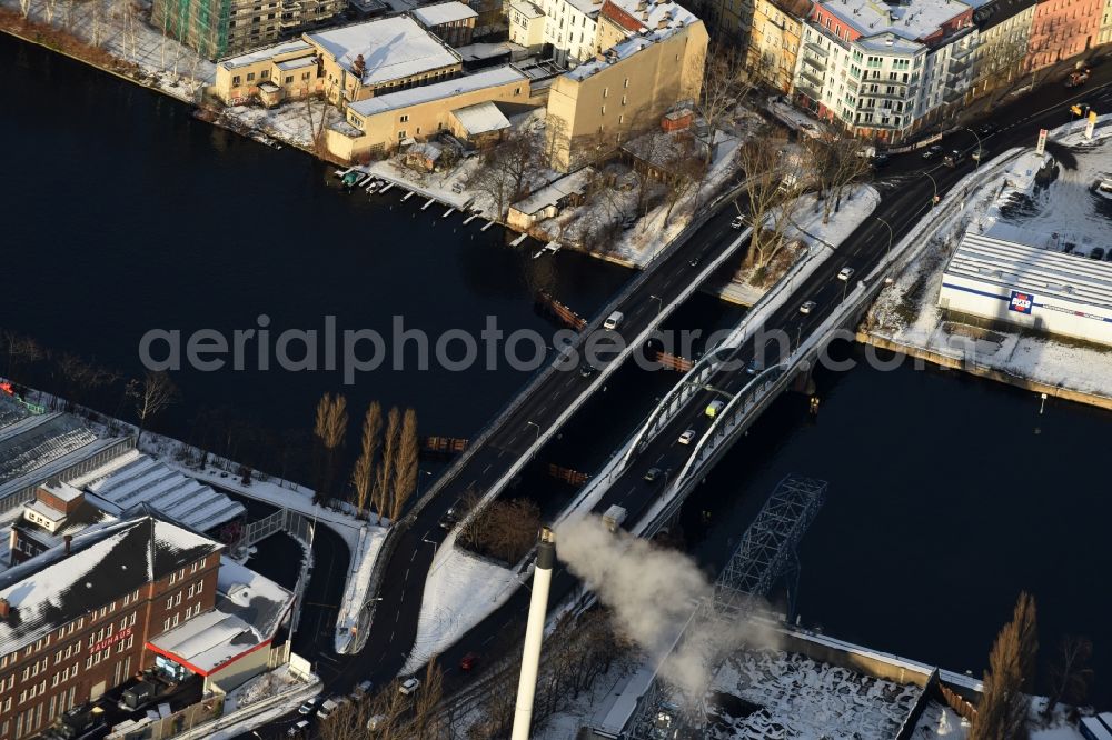 Berlin from the bird's eye view: Wintry snowy river - bridge construction across the river Spree in the district Bezirk Treptow-Koepenick in Berlin