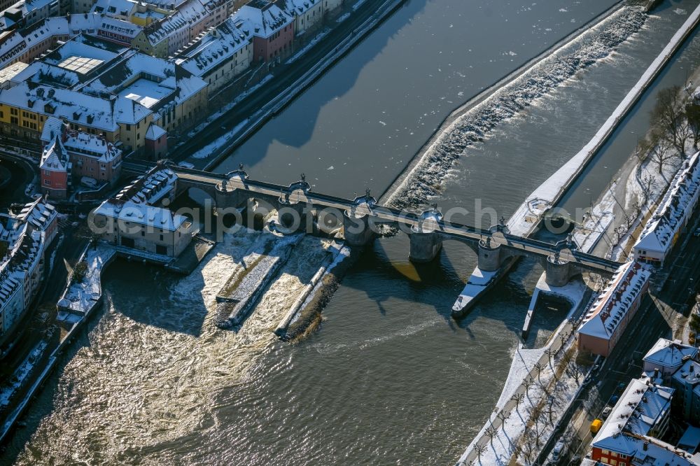 Würzburg from the bird's eye view: Wintry snowy river - bridge construction Alte Mainbruecke in the district Altstadt in Wuerzburg in the state Bavaria, Germany