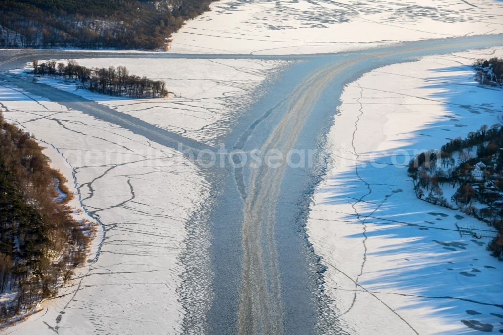 Berlin from above - Winter aerial photo river course and bank areas of the frozen Havel river with navigation channel near Berlin Nikolassee in the German state of Berlin