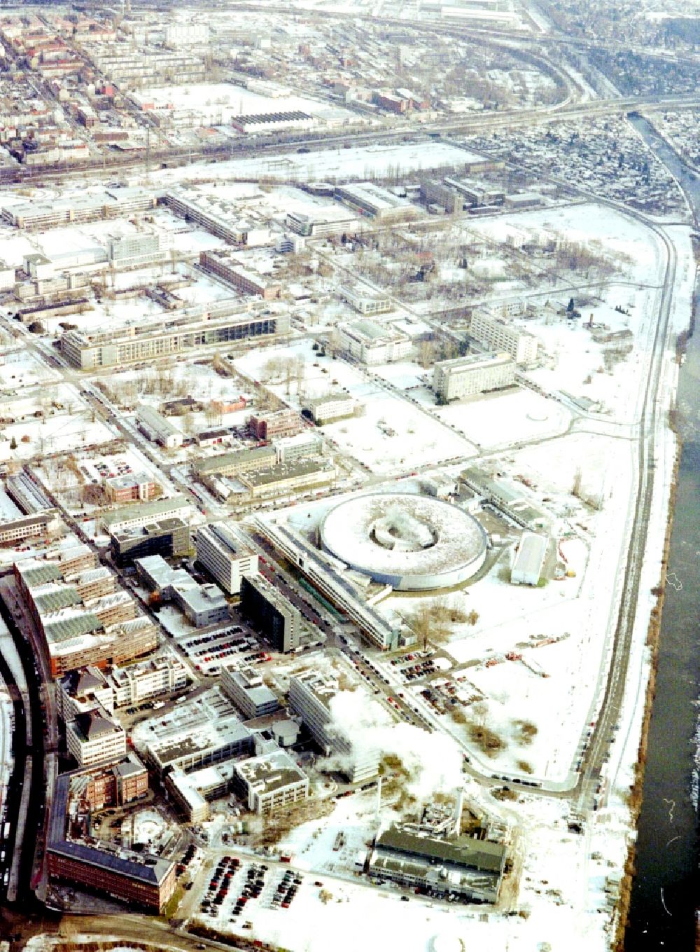 Aerial photograph Berlin - Wintry snowy research building and office complex Elektronen- Speicherring BESSY - Synchrotronstrahlungsquelle in the district Adlershof in Berlin, Germany