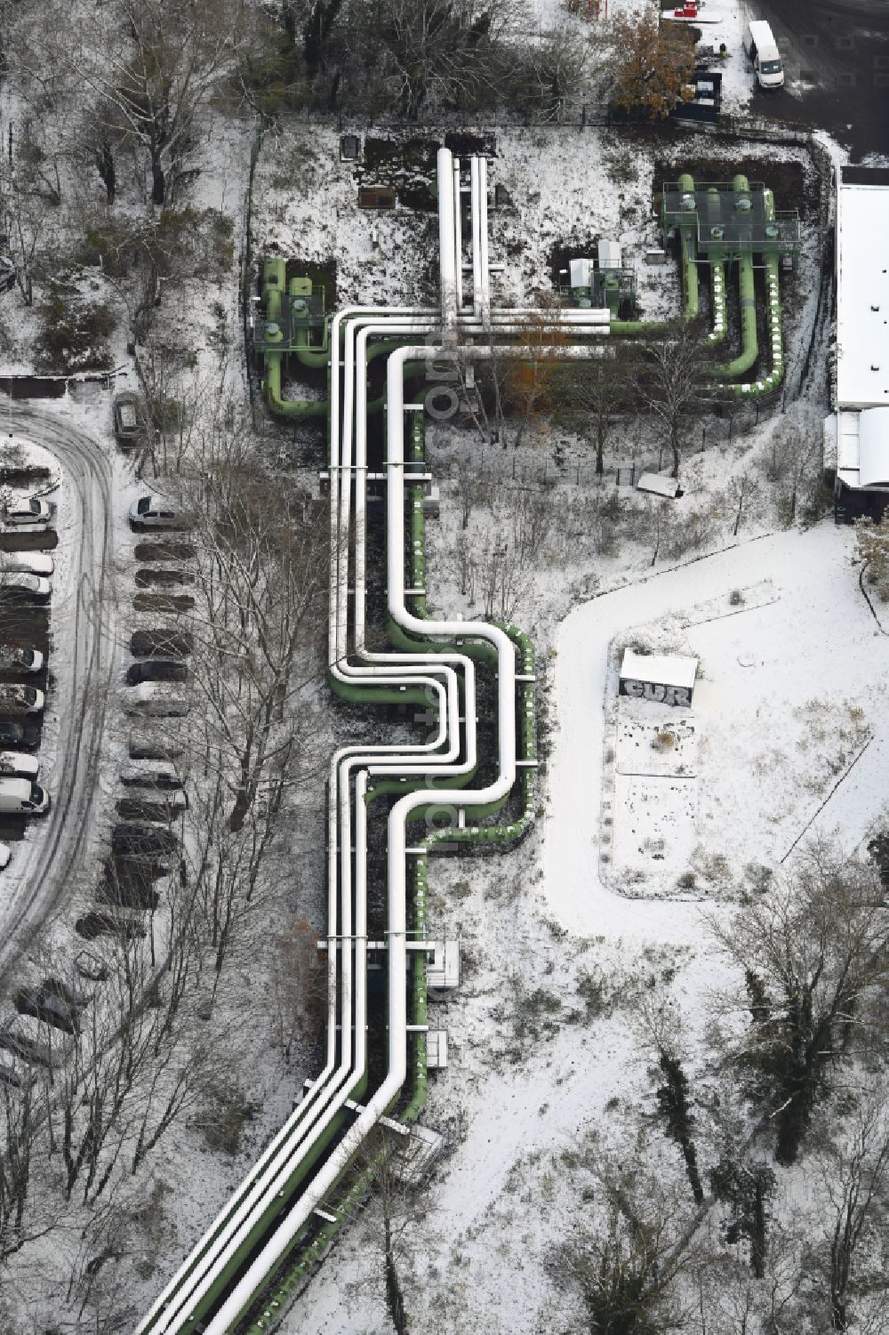 Aerial image Berlin - Wintry snowy overhead pipes for district heating supply along the Rhinstrasse in the district Lichtenberg in Berlin, Germany